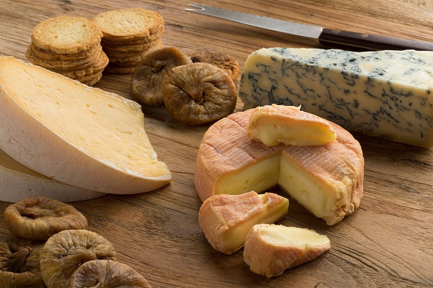 A lovely selection of cheese for delivery sits on a breadboard at The Cheese Wheel.